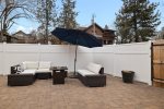 Fenced backyard, patio with outdoor dining, umbrellas, gas fire pit, hot tub